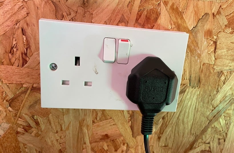 Electric Scooter Charger Plugged In